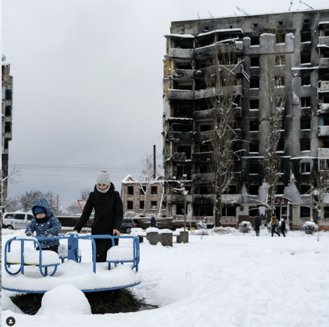 A mother and her little son are playing on a playground in a war-torn city Borodyanka, Kyiv region, Ukraine.